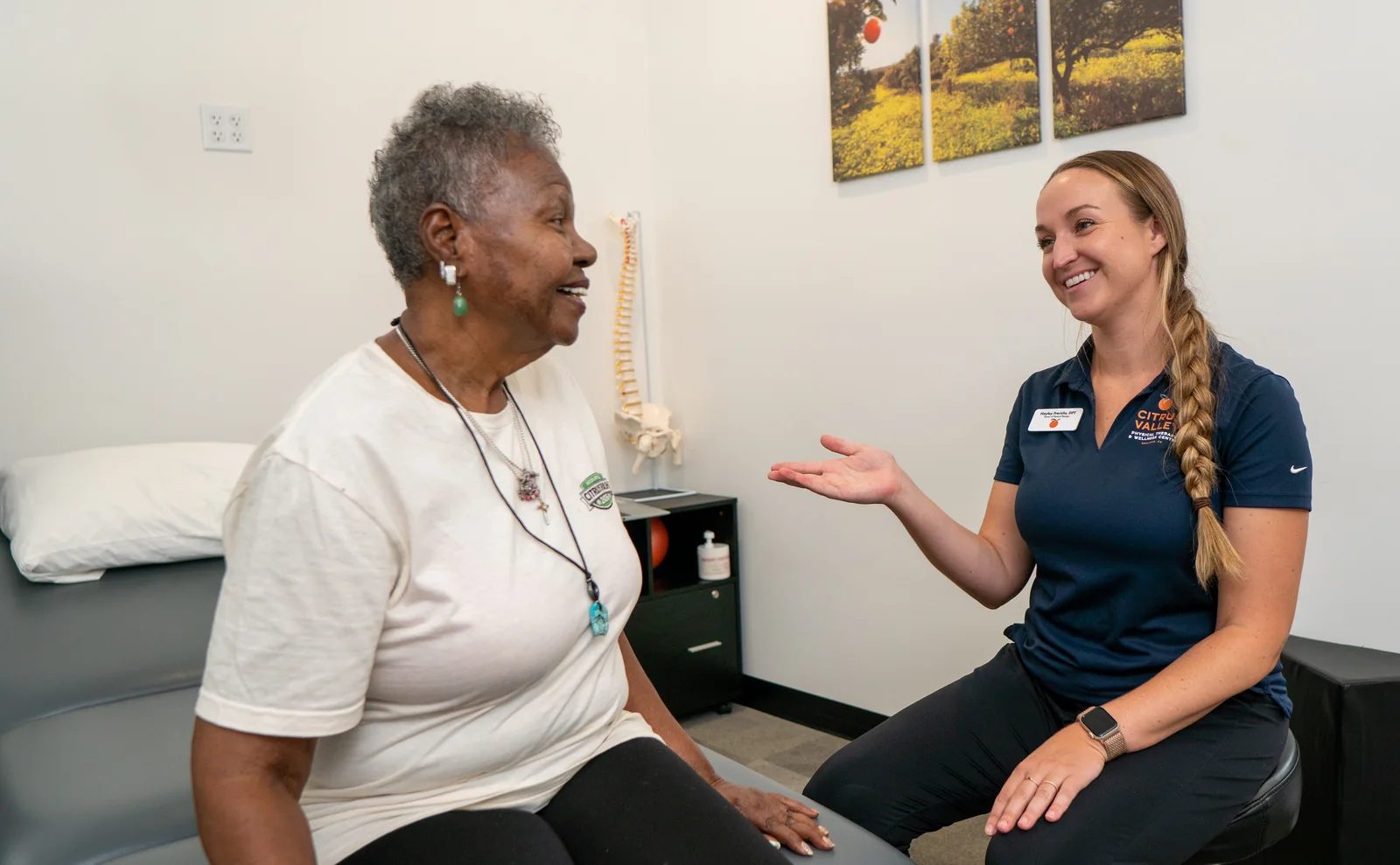 Citrus Valley physical therapist talking with a smiling patient in a treatment room