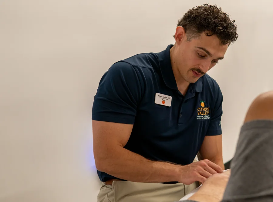 Physical therapist examining a patient's knee in the Citrus Valley clinic
